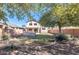 Large backyard with a grassy area, mature trees, and block wall fencing at 17059 W Northampton Rd, Surprise, AZ 85374