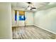 Cozy bedroom with wood-look flooring, a ceiling fan, and natural light at 17059 W Northampton Rd, Surprise, AZ 85374