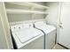 Laundry room with washer, dryer, and shelving for storage at 17059 W Northampton Rd, Surprise, AZ 85374