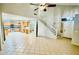 Open living space with tile flooring, high ceilings, and staircase access at 17059 W Northampton Rd, Surprise, AZ 85374