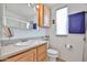 Bright bathroom featuring wooden vanity, toilet, and ample counter space at 17200 W Bell Rd # 1185, Surprise, AZ 85374