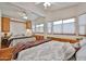 Relaxing bedroom with built-in cabinets, a large mirror, and bright natural light at 17200 W Bell Rd # 1185, Surprise, AZ 85374