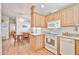 Efficient kitchen connected to dining area with modern appliances and light wood cabinetry at 17200 W Bell Rd # 1185, Surprise, AZ 85374