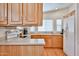 Well-lit kitchen with light wood cabinets, modern appliances, and ample counter space at 17200 W Bell Rd # 1185, Surprise, AZ 85374