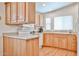 Bright kitchen with light wood cabinets, modern appliances, and ample natural light at 17200 W Bell Rd # 1185, Surprise, AZ 85374