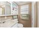 This bathroom includes a sink, toilet, and built-in shelving at 17200 W Bell Rd # 119, Surprise, AZ 85374