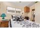 Bedroom featuring neutral walls, patterned bedding, bedside table with lamp, and closet at 17200 W Bell Rd # 119, Surprise, AZ 85374