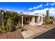 Single-story home featuring covered parking, desert landscaping and an inviting curb appeal at 17200 W Bell Rd # 119, Surprise, AZ 85374