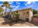 Rear exterior view of the property with desert landscaping, ladder and blue sky at 17200 W Bell Rd # 119, Surprise, AZ 85374