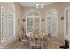 Bright dining area featuring multiple arched windows and a circular table with decorative chairs at 18932 N 89Th Way, Scottsdale, AZ 85255