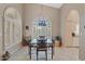 Charming dining area with unique light fixture and arched windows with custom shutters at 18932 N 89Th Way, Scottsdale, AZ 85255