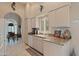 Well-lit kitchen featuring granite counters, white appliances, and views into an adjacent dining space at 18932 N 89Th Way, Scottsdale, AZ 85255