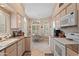 Well-equipped kitchen features granite countertops, white cabinets, and arched windows at 18932 N 89Th Way, Scottsdale, AZ 85255