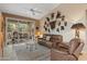 Cozy living room features tile floors, a decorative wall, a leather couch, and access to a patio at 18932 N 89Th Way, Scottsdale, AZ 85255