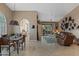 Open-concept living room with tile floors, dining area, an adjacent kitchen, and access to the patio at 18932 N 89Th Way, Scottsdale, AZ 85255