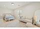 Bright bedroom with a seating area and shuttered windows at 20216 E Sunset Ct, Queen Creek, AZ 85142