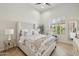 Relaxing bedroom with upholstered bed and natural light streaming in through shutters at 20216 E Sunset Ct, Queen Creek, AZ 85142