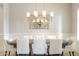 Formal dining room with wainscoting, chandelier, and long table with seating for eight at 20216 E Sunset Ct, Queen Creek, AZ 85142