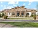 Stunning stone front exterior with manicured lawn, creating a welcoming and sophisticated curb appeal at 20216 E Sunset Ct, Queen Creek, AZ 85142