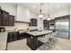 Gourmet kitchen featuring dark wood cabinetry, a large island, and modern appliances for culinary enthusiasts at 20216 E Sunset Ct, Queen Creek, AZ 85142