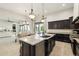 This kitchen features a large granite island with sink, stainless steel appliances, and dark wood cabinetry at 20216 E Sunset Ct, Queen Creek, AZ 85142