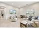 Inviting living room with gray couches, decorative pillows, a large television, and lots of natural light at 20216 E Sunset Ct, Queen Creek, AZ 85142