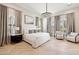 Luxurious main bedroom suite with stunning chandelier and herringbone floors at 20216 E Sunset Ct, Queen Creek, AZ 85142