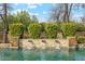 Beautiful pool featuring a stone waterfall feature and lush green landscaping at 20216 E Sunset Ct, Queen Creek, AZ 85142