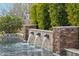 Tranquil pool showcasing a decorative waterfall feature and mature foliage at 20216 E Sunset Ct, Queen Creek, AZ 85142