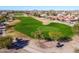 An aerial view of the green golf course, nestled within the community's landscape at 22569 W Lasso Ln, Buckeye, AZ 85326