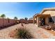 Gravel backyard with desert landscaping, decorative stone pathway, and covered patio at 22569 W Lasso Ln, Buckeye, AZ 85326