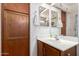 Bathroom with cabinets, large mirror, and a vanity with sink, offering a functional space at 22569 W Lasso Ln, Buckeye, AZ 85326