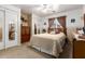 Well-lit bedroom with decorative furniture and closet featuring mirrored doors and a ceiling fan at 22569 W Lasso Ln, Buckeye, AZ 85326