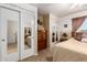 Cozy bedroom with twin closets with mirrored doors and a comfortable bed providing ample storage at 22569 W Lasso Ln, Buckeye, AZ 85326