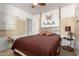 Inviting bedroom featuring a ceiling fan and a comfortable bed with stylish decor at 22569 W Lasso Ln, Buckeye, AZ 85326