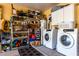 Organized garage with washer, dryer, shelving, and ample storage space at 22569 W Lasso Ln, Buckeye, AZ 85326