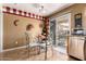 Cozy breakfast nook with table and chairs next to a sliding glass door and stainless steel dishwasher at 22569 W Lasso Ln, Buckeye, AZ 85326