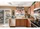 Kitchen area with stainless appliances, cabinets, and a view of the outdoor patio through sliding glass doors at 22569 W Lasso Ln, Buckeye, AZ 85326