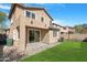 A lush backyard with a well-manicured lawn, patio, and a view of the home's rear exterior at 2331 E Pecan Rd, Phoenix, AZ 85040