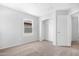 A simple, carpeted bedroom offers closet space and natural light from a double hung window at 2331 E Pecan Rd, Phoenix, AZ 85040