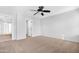 Bright bedroom featuring neutral carpet and a modern ceiling fan, with doorway to hall and bath at 2331 E Pecan Rd, Phoenix, AZ 85040