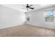 Bright bedroom with carpet flooring, two windows, and a ceiling fan creating a calm ambiance at 2331 E Pecan Rd, Phoenix, AZ 85040