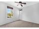 Bedroom with neutral carpet, ceiling fan, and windows offering abundant natural light at 2331 E Pecan Rd, Phoenix, AZ 85040