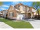 Two-story home showcasing desert landscaping, neutral stucco and a two car attached garage at 2331 E Pecan Rd, Phoenix, AZ 85040