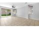 Spacious living room with tile flooring, fan, and a sliding glass door to the outside at 2331 E Pecan Rd, Phoenix, AZ 85040