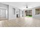 An open-concept living room with tiled floors, fan, and a view into kitchen at 2331 E Pecan Rd, Phoenix, AZ 85040