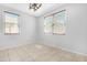 A naturally lit room with tile flooring, white walls, and modern blinds on the dual windows at 2331 E Pecan Rd, Phoenix, AZ 85040