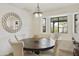 Bright dining area with a round table, stylish seating, and a window offering natural light at 2440 E Hale St, Mesa, AZ 85213