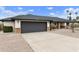 Attractive home showcasing a spacious driveway, two-car garage, and brick accents at 2440 E Hale St, Mesa, AZ 85213