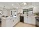 Modern kitchen featuring white cabinets, quartz countertops, a breakfast bar, and stainless steel appliances at 2440 E Hale St, Mesa, AZ 85213